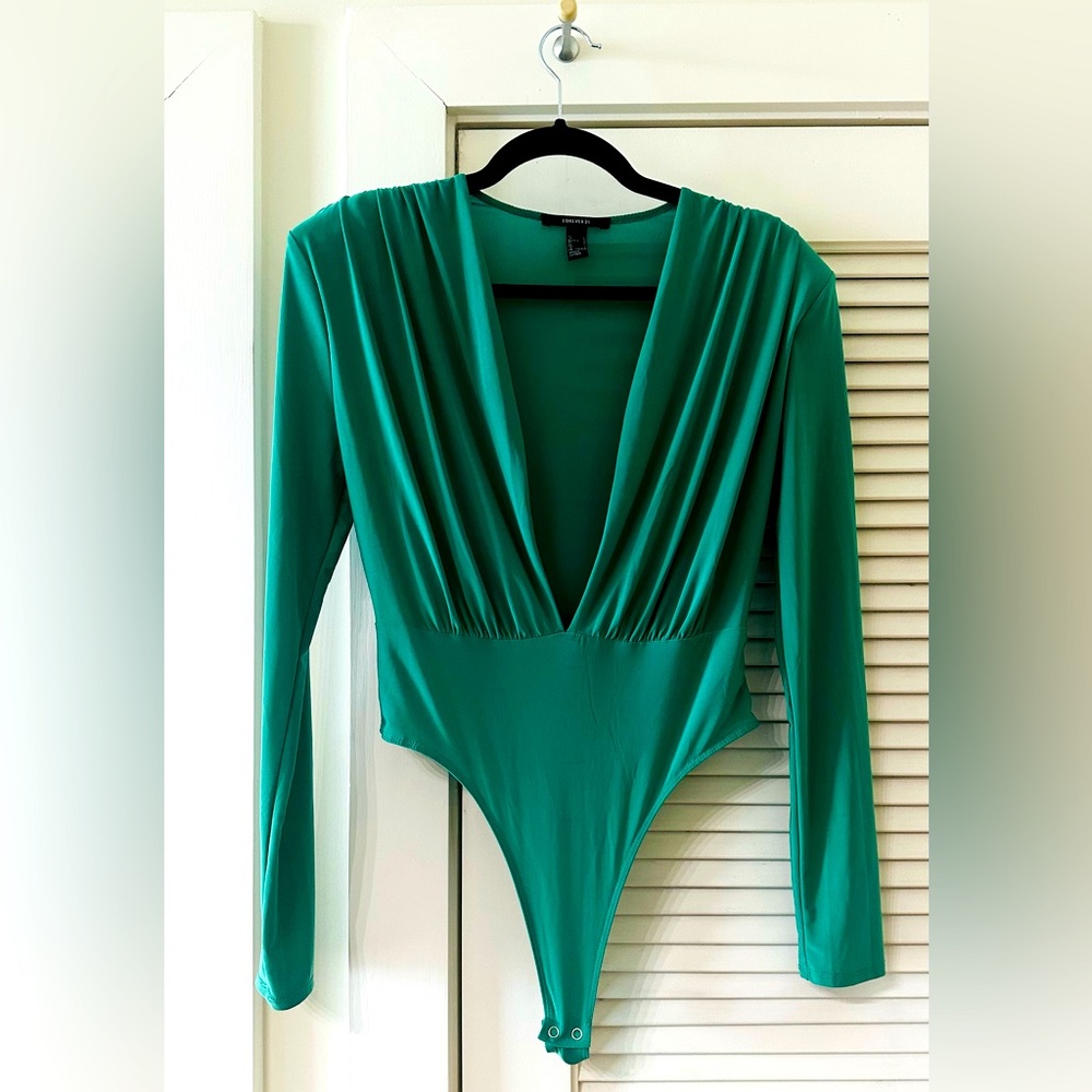 Stylish green V-neck bodysuit top!!! Polyester and spandex.
